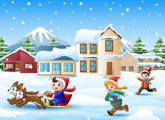 Cartoon boy riding sled on the snowing village with running kids