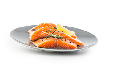 Salmon. Raw salmon steaks herb peper lemon on white background.