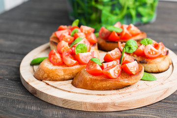 Traditional Italian bruschetta with tomatoes and spinach