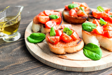 Traditional Italian bruschetta with tomatoes and spinach