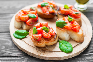 Traditional Italian bruschetta with tomatoes and spinach