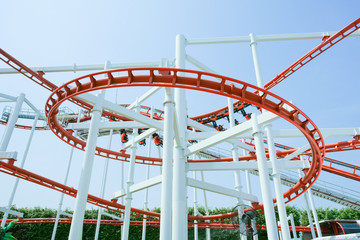 Funny with Roller Coaster in amusement park