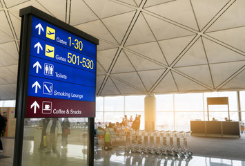 Information board light box, boarding gate direction with blurred Airport Background.