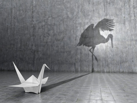 Concept of hidden potential. A paper crane that throws the shadow of a real crane. 3D illustration