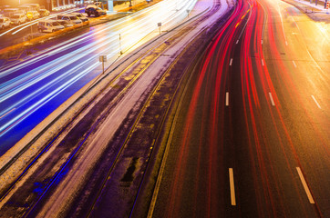 Speed Traffic light trails on motorway highway at night, long exposure abstract urban background.
