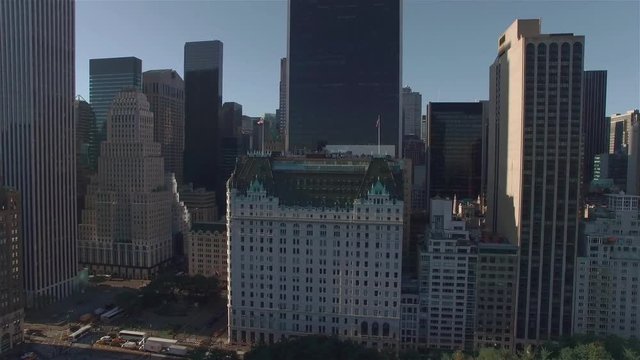 Aerial real time shot, camera is moving backward above Central park and filming intersection of West 95th Street and 5th Avenue