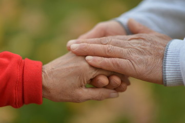 Elderly couple holding hands