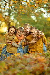 Fototapeta premium smiling family in autumn forest 