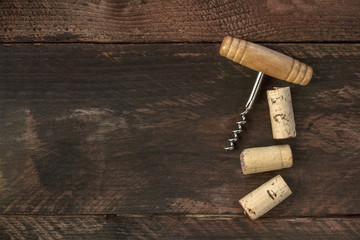 Fototapeta na wymiar Photo of wine corkscrew and corks on dark background