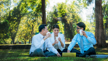 Business people having a business conversation and meeting in the park