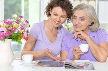 mother and daughter reading magazine