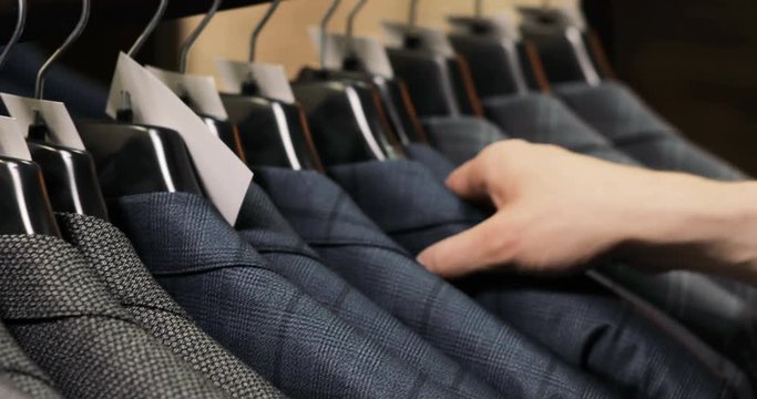 Man choosing a suit at tailor's shop