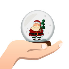 Hand holds a glass ball with Santa