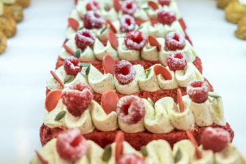 Pieces of homemade raspberry cake on an cafe window