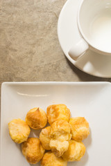 Choux Dough on a plate, white background loft and have a cup of coffee