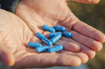 guy is holding a pill