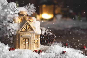 Fototapeta na wymiar decorative christmas decorations, a house on a snowy background