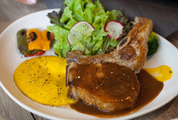 Pork chop steak with sauce and side dish