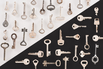 top view of different vintage keys over black and white background