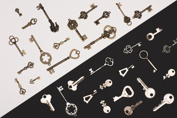 top view of different vintage keys over black and white background
