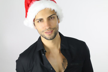 Handsome man in Santa hat on a white background 