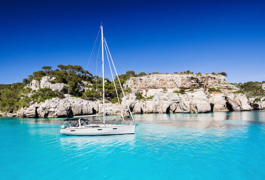 Beautiful bay in Mediterranean sea with sailing boat, Menorca island, Spain