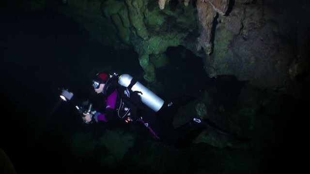 Scuba diving underwater in caves of Yucatán Mexico cenotes. Clean and clear underground water.
