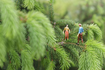 Miniature figures talking on the tree