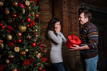 Merry Christmas. Young couple celebrating Christmas at home