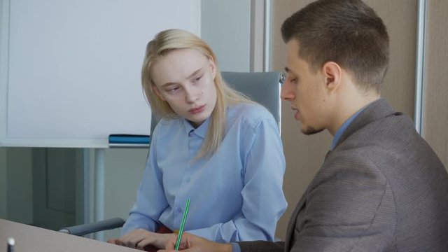 The male finansist has a privete meeting with his female boss in her office