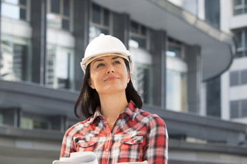 Engineer woman is looking at building