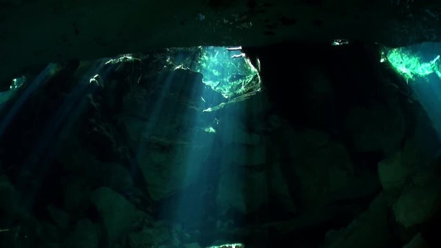 Yucat&aacute;n caves of cenotes underwater in Mexico. Scuba diving in clean and clear underground water in reflection sunlight.