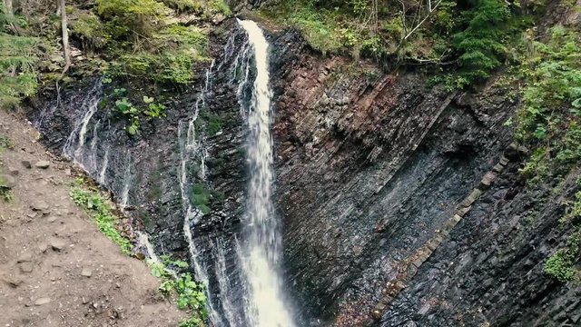 Beautiful autumn waterfall Zhenetskyi Huk in carpathian mountains, Ukraine. Aerial shoot from drone
