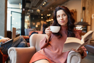 woman drinking coffee in a cafe - 183728076