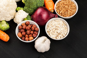 Fresh raw vegetables with nuts and cereals for cooking or eating. Vegetarian food. Top view