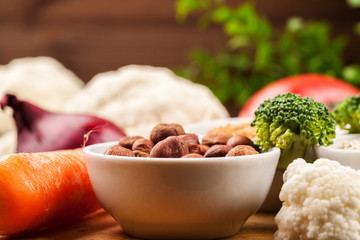 Fresh raw vegetables with nuts and cereals for cooking or eating. Vegetarian food.