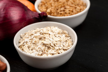 Cereals in a white ceramic dishes with different vegetables closeup shot