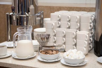 Cups for coffee and tea at the Banquet. The self-serve station. Coffee, sugar, cream, and Cutlery and crockery.