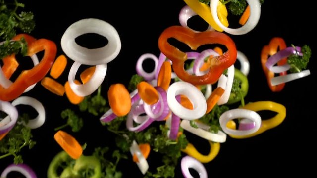 Falling cuts of colorful vegetables, slow motion