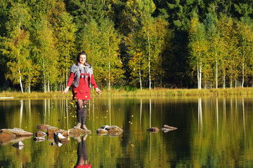 Fototapeta na wymiar Beautiful woman spending time in park during autumn season