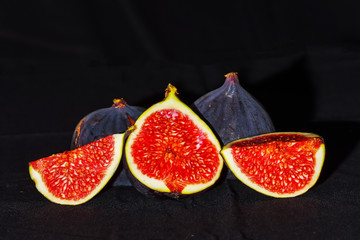 Closeup of fig fruit wedges on a dark background