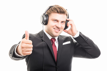 Young manager holding headphone showing like gesture