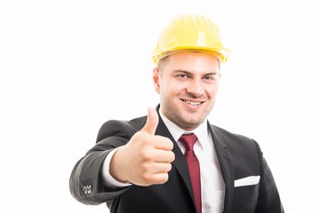 Constructor wearing suit and hardhat showing like gesture