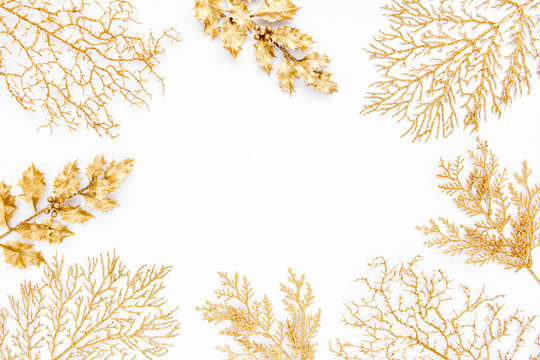 Christmas or new year frame composition. Pattern made of golden leaves on white background. Flat lay, top view, copy space