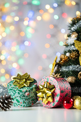 christmas decoration on bright background, gift boxes and tree