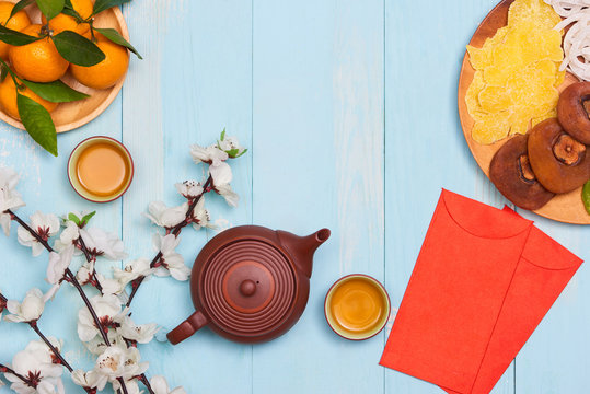 Conceptual flat lay Chinese New Year food and drink still life. Text appear in image: Prosperity, spring & good fortune.