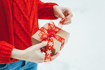 Girl holds a Christmas gift in her hands