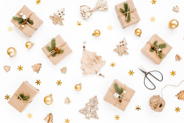 Fototapeta na wymiar Christmas frame, pattern made in gold colors and craft boxes on white background with empty copy space for text. Holiday and celebration concept. Top view. Flat lay