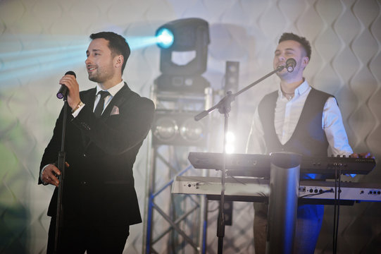 Musicial music live band performing on a stage with different lights.