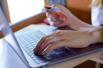 Woman using laptop payment online 